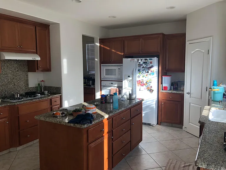 Kitchen with island, gas stove, refrigerator