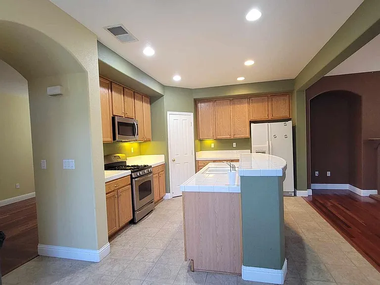 Kitchen sink in center island with loads of counterspace