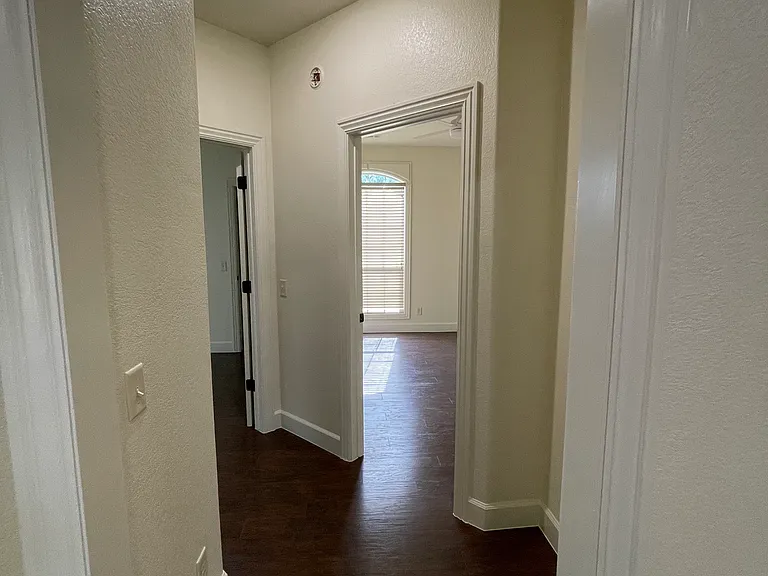 Hallway to bathroom and two bedrooms