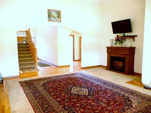 Formal living room with electric fireplace. The powder room & master suite are to the right
