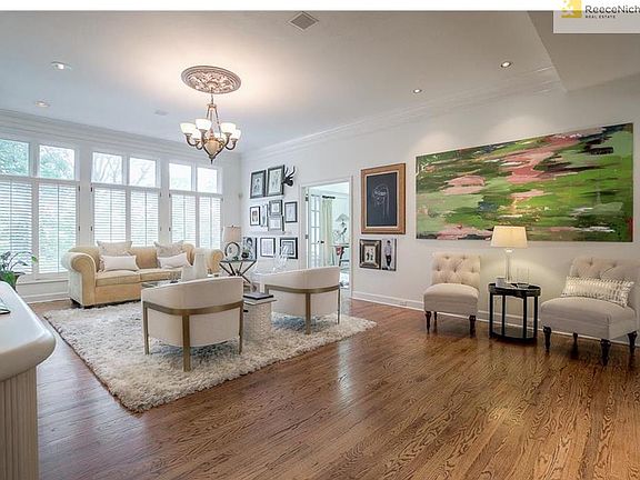 Large living room with plantation shutters, fireplace and gas logs.