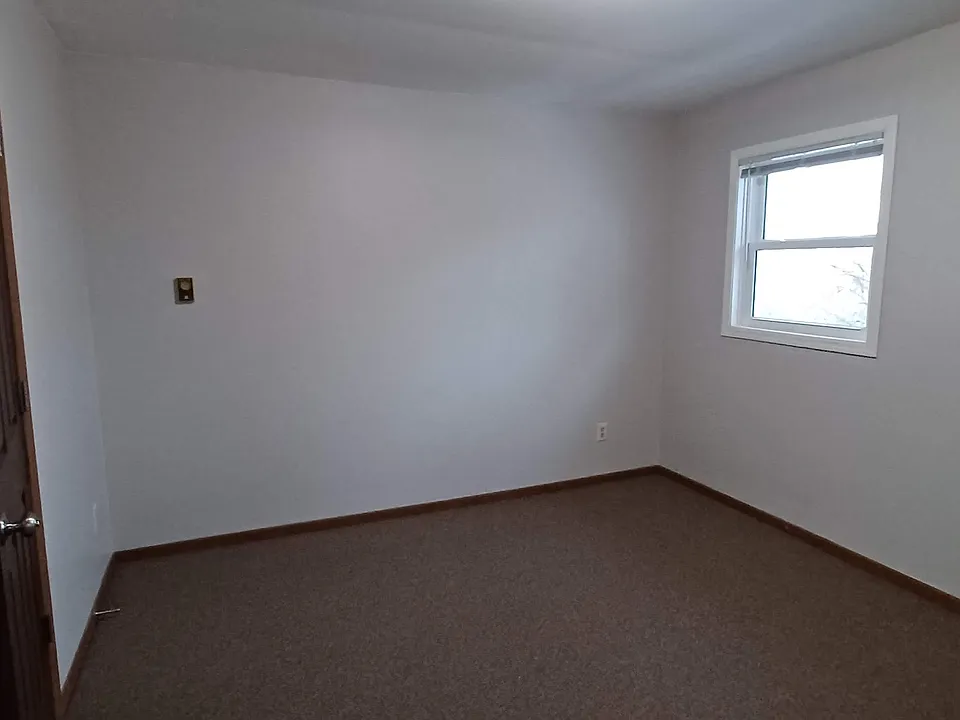 Bedroom 1. Adjacent to the bathroom.