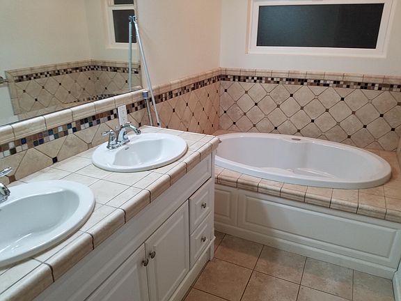 Upstair bathroom: shower, double sink, and spa