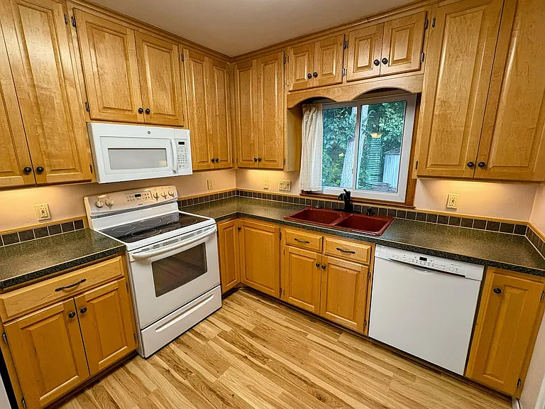 Beautifully updated kitchen, Custom Maple Cabinetry. All kitchen appliances and upgraded HE Washer/Dryer included.