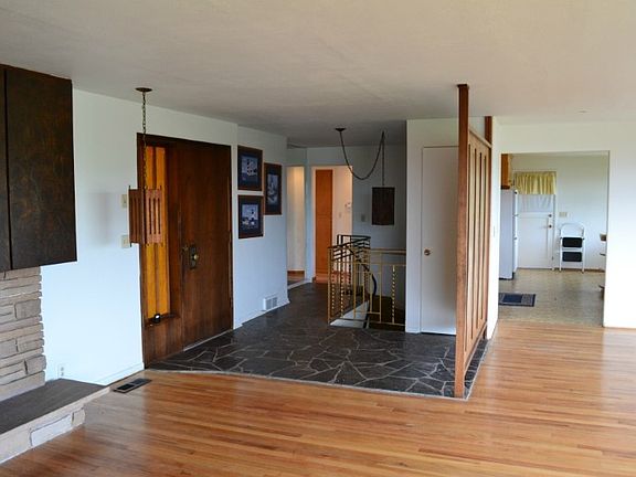 Slate entry into an open and inviting living area. Owners just pulled the carpets and it seems like the oak floors are in original condition - very nice!