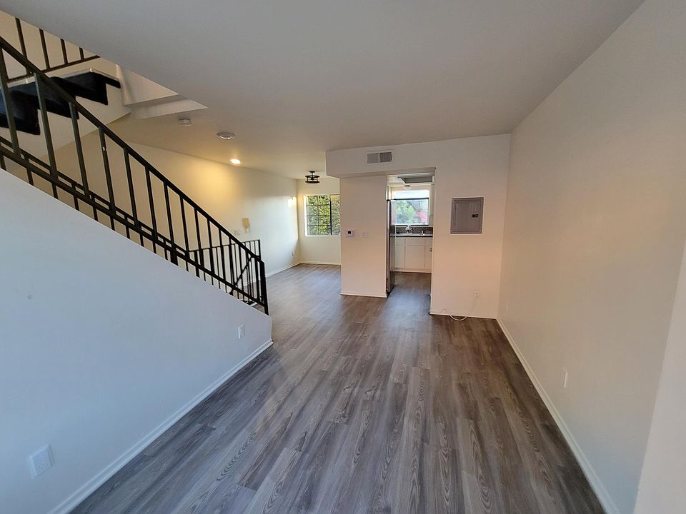 View from Living Rm of Kitchen & Dining Rm and Stairs to Bedrooms