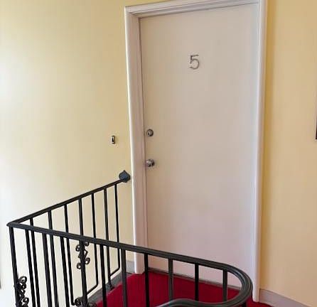 Front door at the top of a single flight of stairs