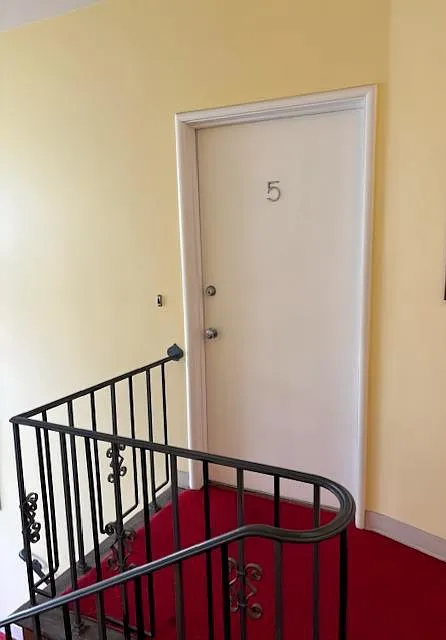 Front door at the top of a single flight of stairs