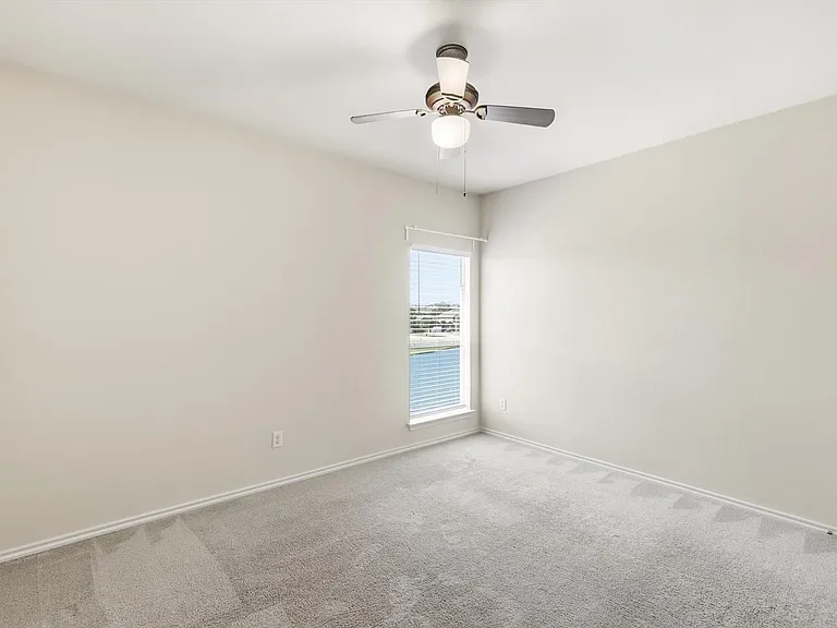 Bedroom 3 up with window facing the water and fan