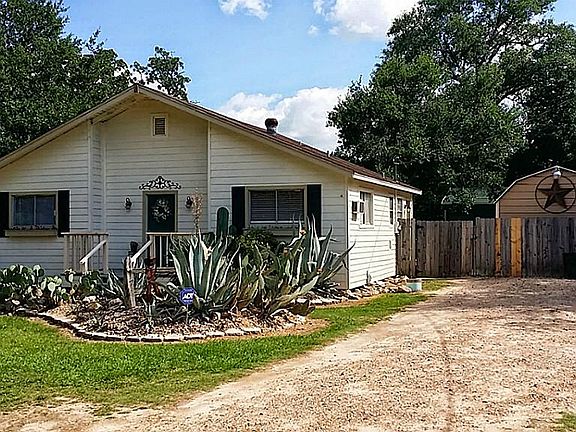 Behind the fence is a 12 x 24 + a 24 x 24 Shop with Rollup Door on a slab!