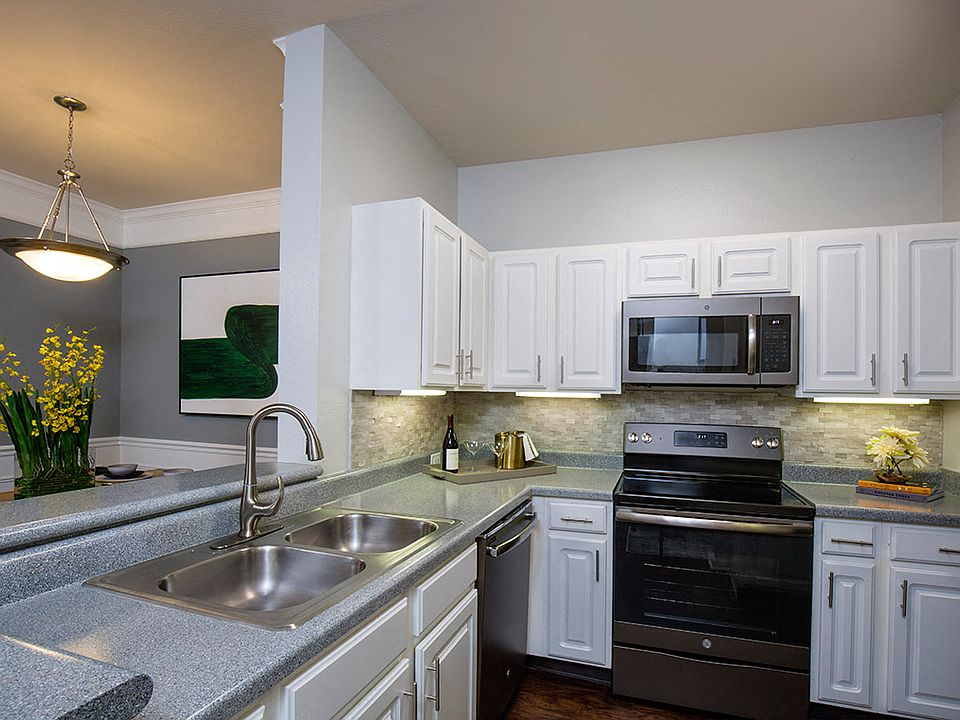 Kitchen with Slate Appliances and White Cabinetry