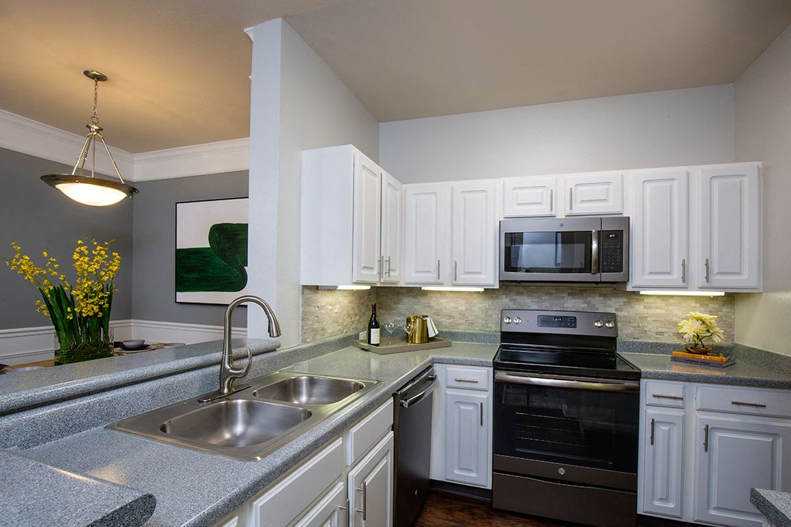 Kitchen with Slate Appliances and White Cabinetry