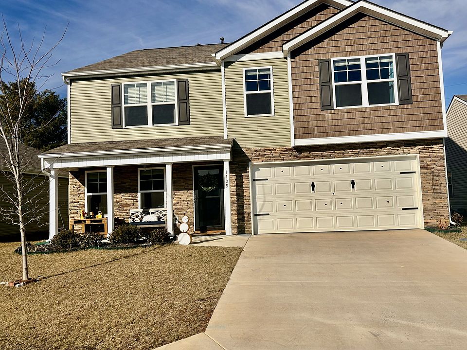 Front of the house has a porch with a sitting area where you can enjoy your morning coffee with mountain views