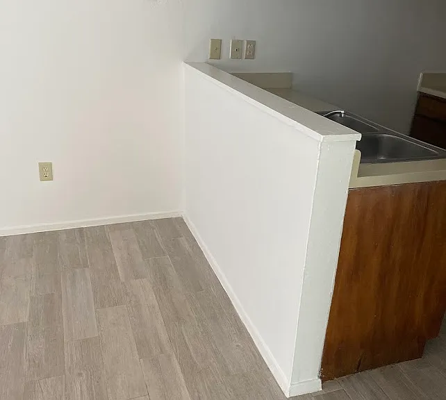 Grey Flooring of livingroom and kitchen separation