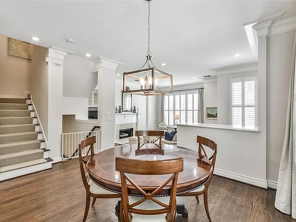 Dining area sits between the living and kitchen featuring stunning chandelier and hardwoods that continue throughout the second and third floors.