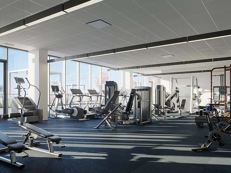 Push your limits in a fully equipped gym, featuring a variety of exercise machines and a large window that fills the space with natural light and fresh air.