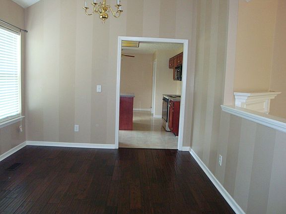 Dining Room has hardwood floor, plant ledges, high ceiling
