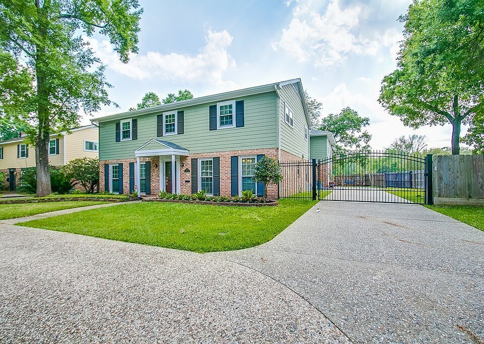 Gated driveway leads to 3 car garage