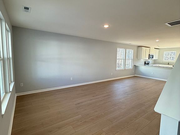 Large living room area will include sectional sofa and TV console and TV. Powder room off living room area.