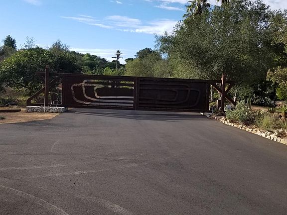 Recently completed entry gate that has multiple cameras for security. Gate art was done by an accomplished artist who also is one of the neighbors.