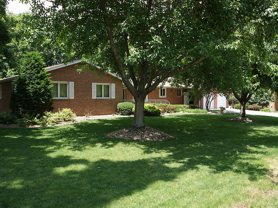 Front view with mature trees