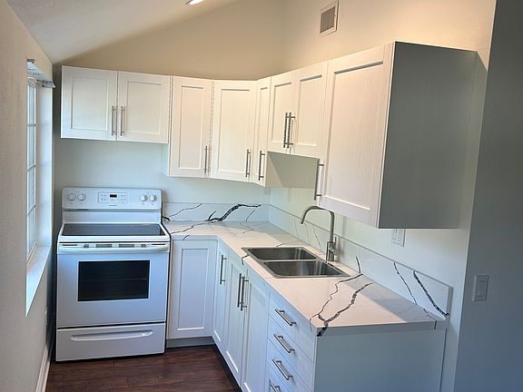 The Kitchen. Refrigerator is not shown in any of the pictures.