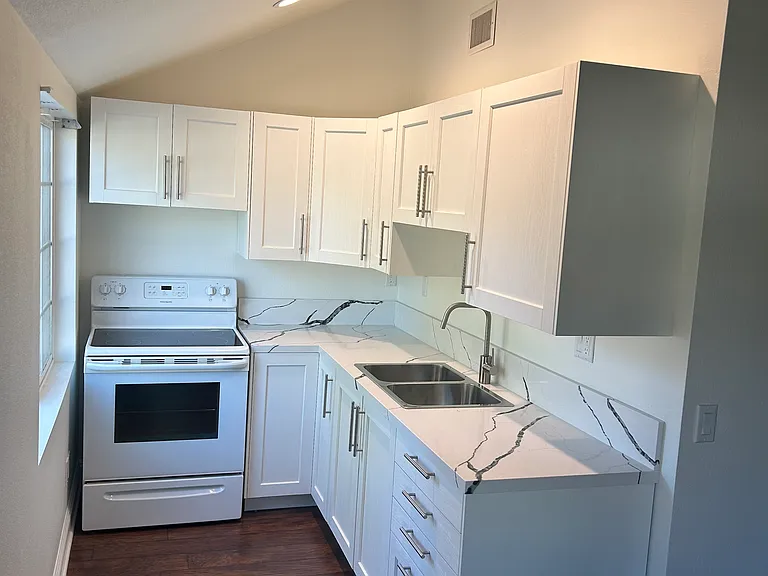 The Kitchen. Refrigerator is not shown in any of the pictures.
