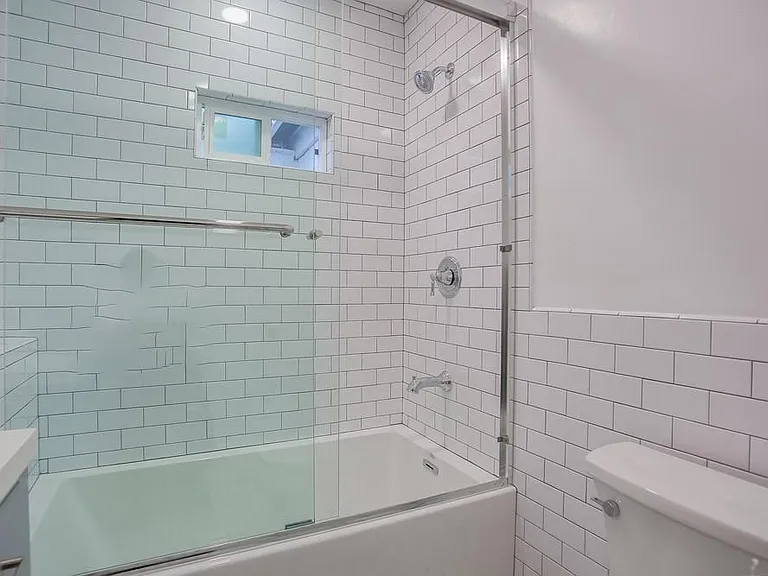 Cottage style subway tile and deep soaking tub.