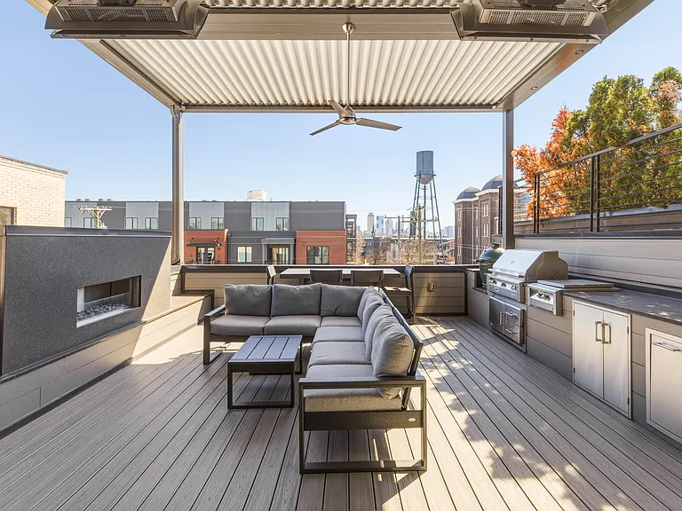 Spacious rooftop patio with a cozy fireplace, BBQ grill, outdoor TV, retractable Nano wall, adjustable louvered roof, LED lighting, wall heaters and plenty of lounge and dining seating_perfect for relaxing evening under the Nashville sky.
