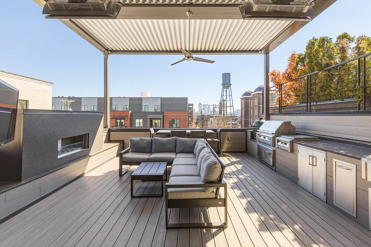 Spacious rooftop patio with a cozy fireplace, BBQ grill, outdoor TV, retractable Nano wall, adjustable louvered roof, LED lighting, wall heaters and plenty of lounge and dining seating_perfect for relaxing evening under the Nashville sky. - 612 Hume St
