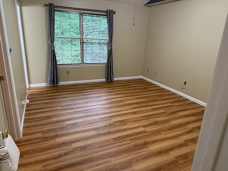 Master bedroom with new flooring, walk-in closet and large ensuite bath