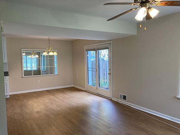 Living Room and Dining Area with door exiting to fenced in patio/side yard.