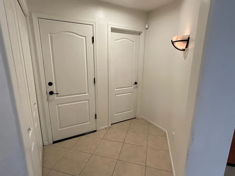 Hallway closet for bedroom three, laundry closet and garage entry