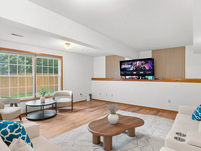 Spacious basement recreation lounge with generous seating and plenty of open space for relaxing, entertaining, or gathering with family and friends.
