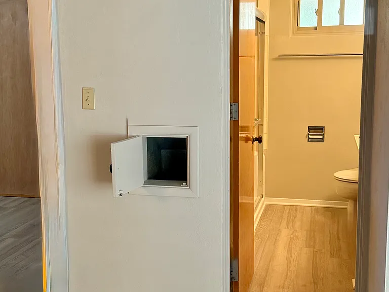 Just beyond mudroom/pantry (left). Highlighting laundry chute) & 1st full bath. Facing South