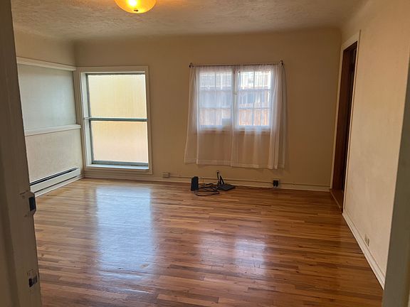 Living area, Hardwoods, natural light, shelving
