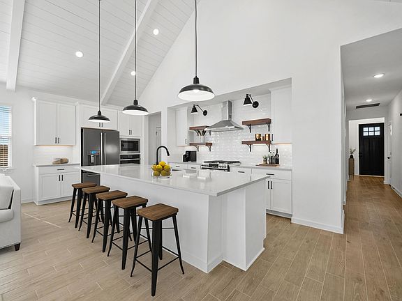 Kitchen with white cabinetry quartz countertops