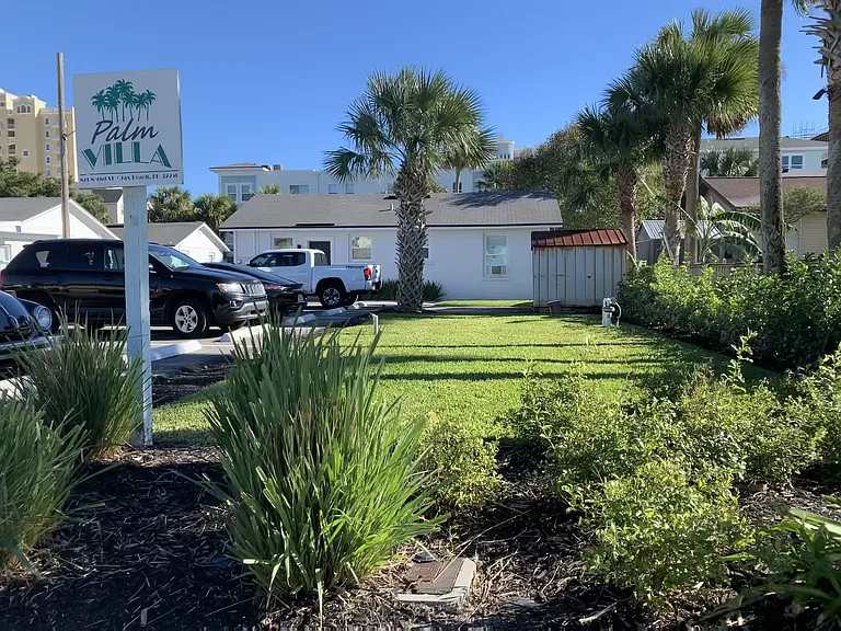 South Side of Property with Palm Villa Sign