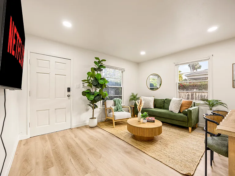 Open living room with smart TV, ideal for relaxing after enjoying nearby beaches, cafes, and attractions.