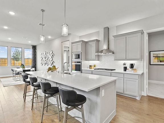Kitchen in the Byron home plan by Trophy Signature Homes - REPRESENTATIVE PHOTO