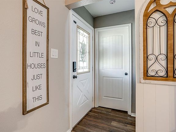 Doorway to outside featuring wood finished floors and baseboards