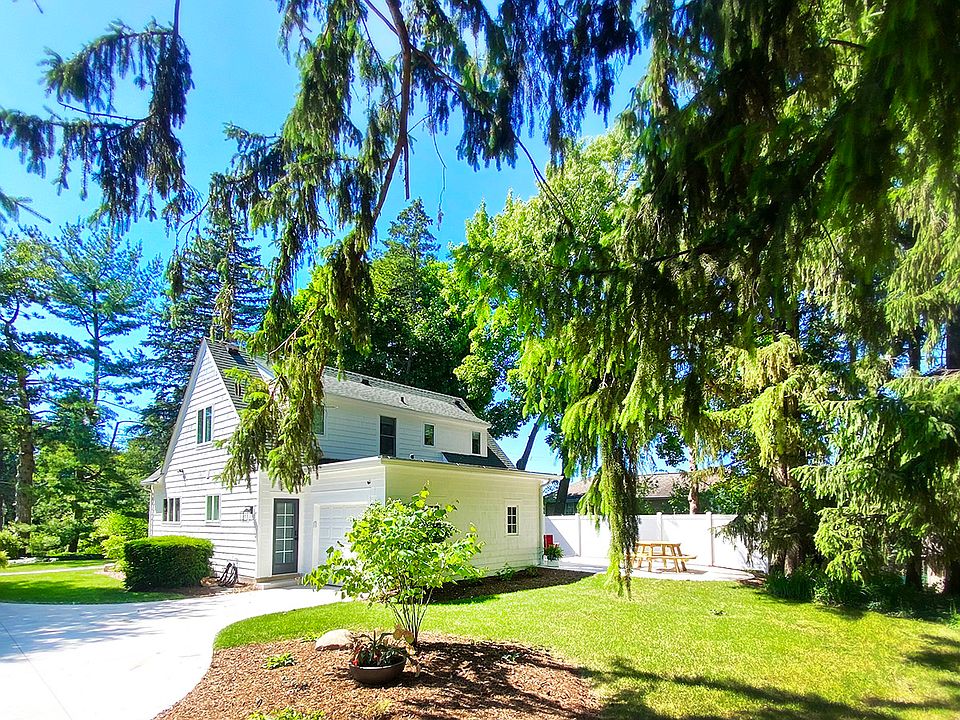 View of property from the back. One stall garage, large driveway for extra vehicles, private back patio.