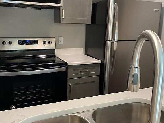 Fully renovated kitchen with new cabinets and appliances and a quartz countertop. Low profile microwave built in and a disposal in the under mount stainless steel sink.