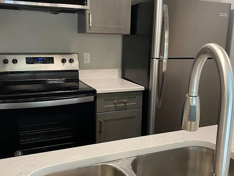 Fully renovated kitchen with new cabinets and appliances and a quartz countertop. Low profile microwave built in and a disposal in the under mount stainless steel sink.