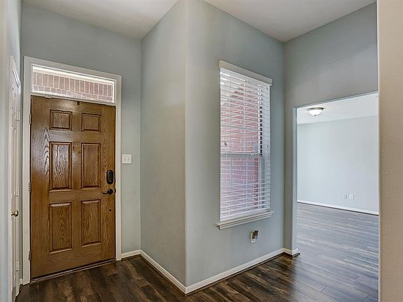The entry of the home has plenty of light with the transom window over the front door and the window next to the front door.