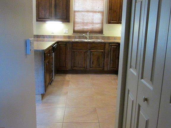 View from guest bath to kitchen with laundry area behind doors on the right.