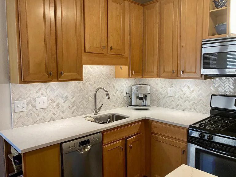 Newly remodeled kitchen with granite countertops and backsplash, dishwasher
