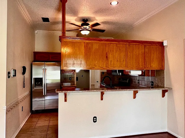 View of breakfast bar and kitchen