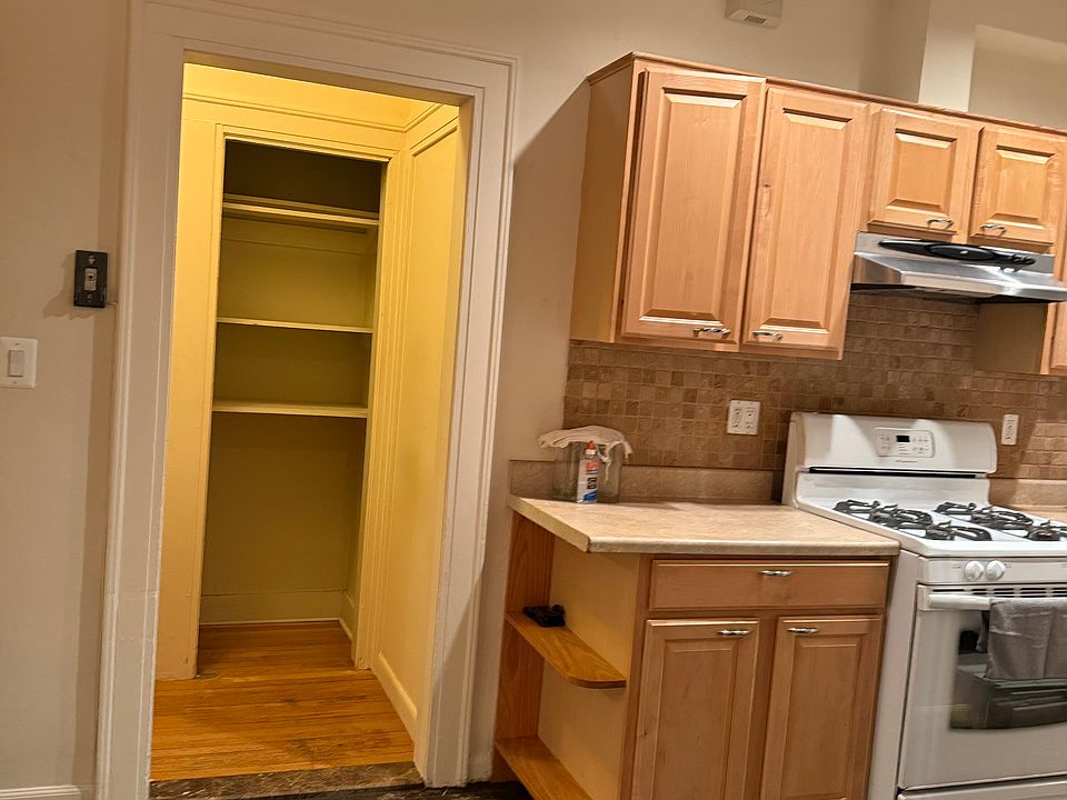 Kitchen looking into linen closet & hallway.