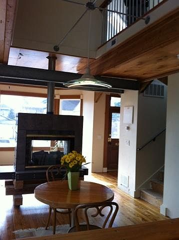 View from dining through two sided fireplace into living roo